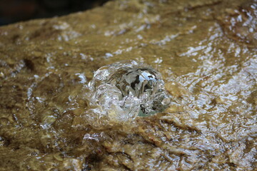 Water flowing from a spring out of a rock
