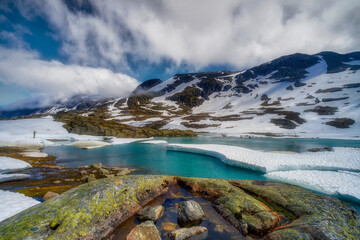 Fototapeta na wymiar Winter view of Scandinavia, melting snow in the high mountains Norway around Hestholmen