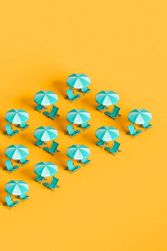 rows of blue beach umbrellas and chairs
