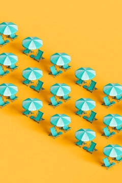 rows of many blue beach umbrellas and chairs