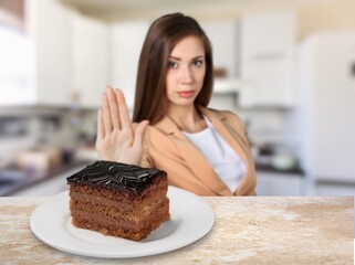 Young teenager girl refuses to eat cake. Say NO to unhealthy food, healthy eating and lose weight...