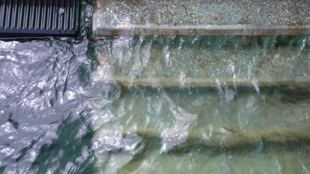 Water crashing on the stairs in a lake during a cloudy day