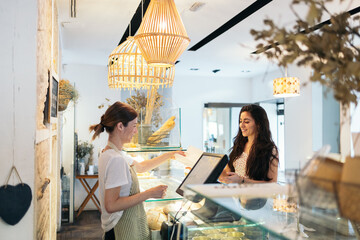 Bakery worker serving a customer