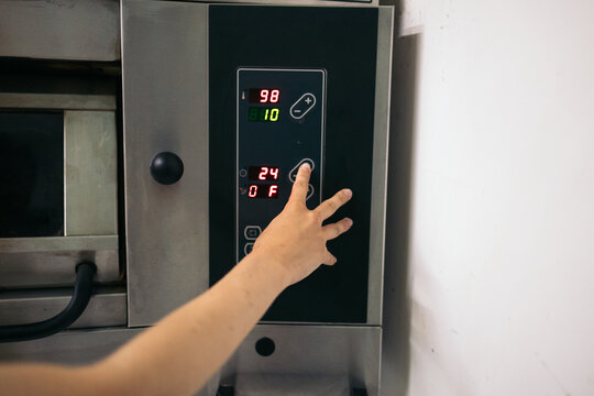 Baker using the pastry oven