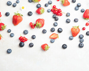 Various fresh berries on neutral background.