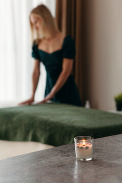 Masseuse prepares cabinet for procedure.