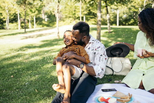 Cheerful father and son in the meadow - Powered by Adobe