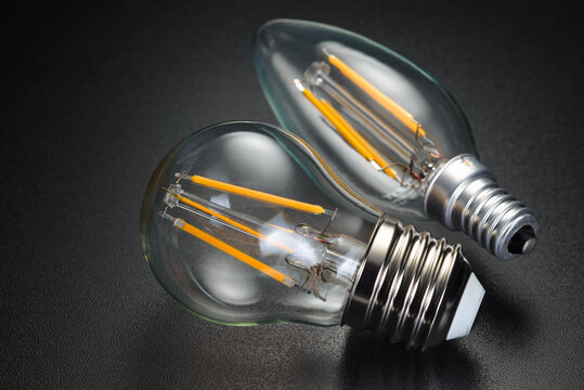 LED filament bulbs on black background.