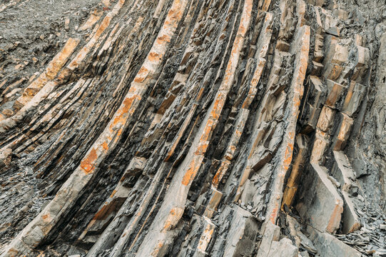 background Rough rocky cliff with uneven surface