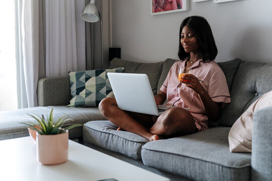 Black woman using laptop at home