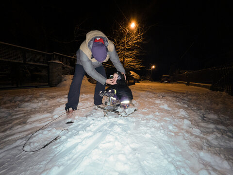 Parent wipes a child's nose during the winter, outdoor