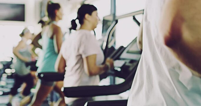 Fit, active and athletic people running on gym treadmills in wellness centre for routine workout, exercise or training. Slow motion of sporty athletes increasing cardio health or managing weight loss