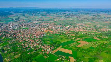 Aerial view on green hilly landscape and small town