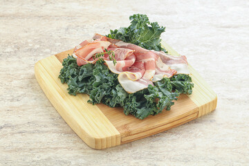 Raw pork bacon over board