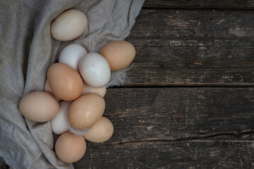 fresh natural organic eggs wooden table background Food Rustic Still Life sack bag wicker basket chicken feathers linen napkin countryside Investment Concept easter  space text Top view hey