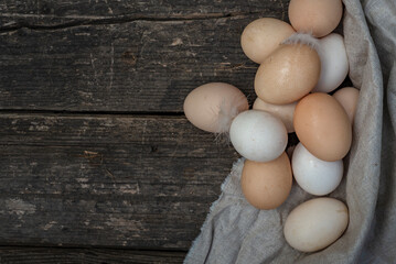 fresh natural organic eggs wooden table background Food Rustic Still Life sack bag wicker basket chicken feathers linen napkin countryside Investment Concept easter  space text Top view hey