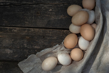 fresh natural organic eggs wooden table background Food Rustic Still Life sack bag wicker basket chicken feathers linen napkin countryside Investment Concept easter  space text Top view hey