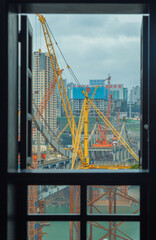 Naklejka premium This is Chongqing, China, where a bridge is being built over the Jialing River to connect the two sides of the river. 