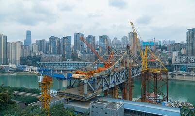 This is Chongqing, China, where a bridge is being built over a large river. This bridge will...