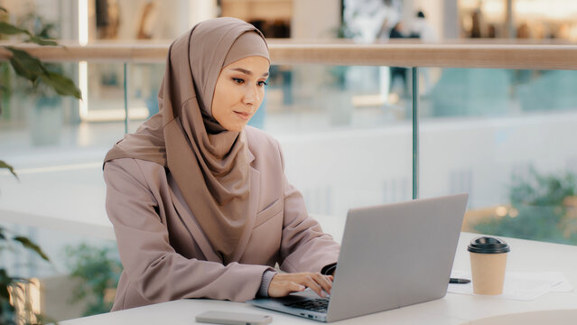 Free Photo  Attractive female arabic working on laptop computer and  paperworks on desk arabian businesswoman working at home dedication and  technology essential for getting her tasks done