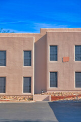 Building exterior with painted stucco wall with rocks near the wall in Tucson, Arizona