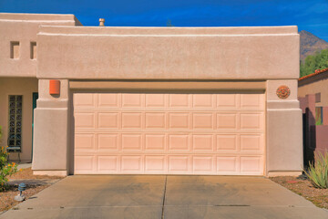 Garage exterior of a painted cream mediterranean home at Tucson, Arizona
