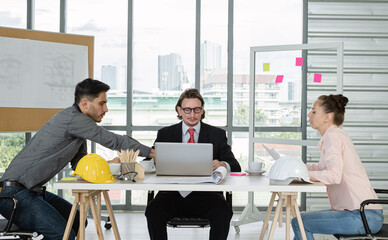 Team of male and female engineers and architects, working team, meeting, discussing construction and drawing construction plans, printing, writing on-site construction sites