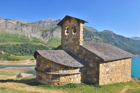 chapel st. magdelene by the lake of roselend in a mountainous landscape french Alps