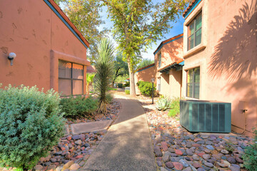 Narrow curved concrete path in the middle of italianate houses in Tucson, Arizona