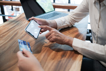 Woman holding credit card and using laptop computer. Online shopping concept.