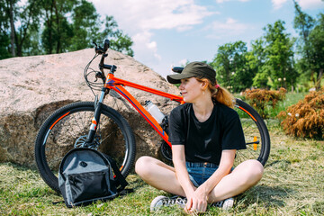 Young attractive woman is resting after bicycle ride. Active lifestyle, sports