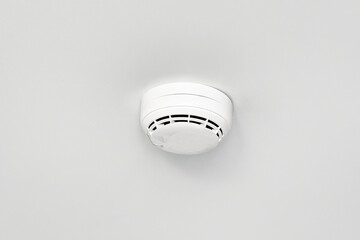 Smoke detector or fire alarm sensor on the ceiling.