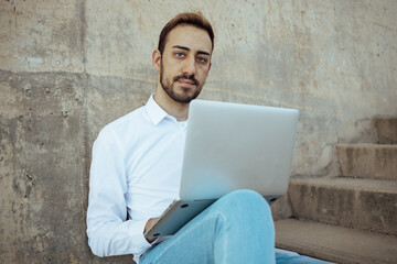 close-up of young man working with computer looking at the camera