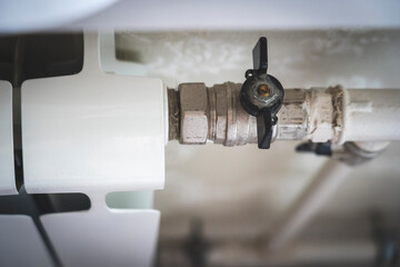 turns the heating on and off. Radiator Heating On The Background of the Wall