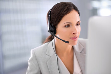Young female call center operator with headset, talking to caller in customer service department. Businesswoman in headphones with microphone consulting client on phone in office space.