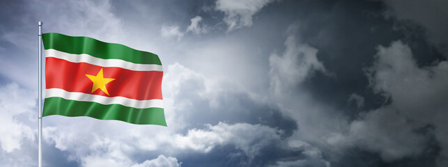 Suriname flag on a cloudy sky