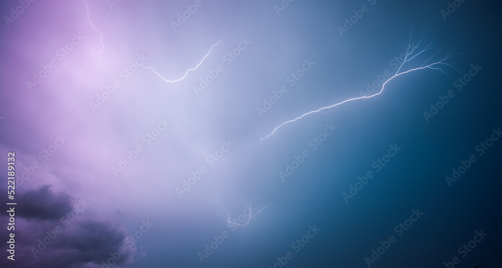 Wall mural A strong storm with bright lightning illuminating ominous clouds.