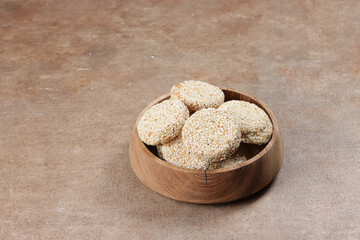 Biskuit marie wijen is traditional Indonesian cookies made from biscuits which dipped in a dissolved sugar and covered with roasted sesame seed.