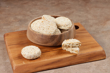 Biskuit marie wijen is traditional Indonesian cookies made from biscuits which dipped in a dissolved sugar and covered with roasted sesame seed.