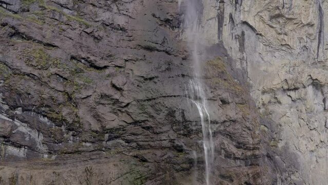 Aerial view of a waterfall surrounded by autumn colors in Lauterbrunnen, Switzerland