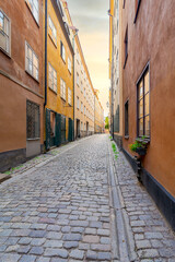 Fototapeta na wymiar Narrow alley located in Gamla stan, the old town of Stockholm, Sweden with old style colorful houses and cobblestone street, Stockholm, Sweden