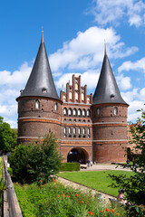 Fototapeta premium Holstentor gate in Lübeck on a sunny day in summer, Lübeck, Germany