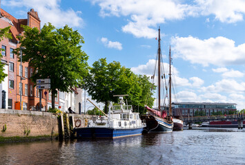 Historical wooden sailing ships in the museum harbor on the river Trave at the quay of the old town of L&uuml;beck