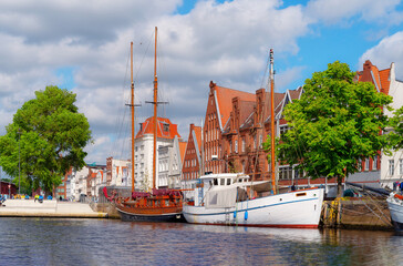 Historical wooden sailing ships in the museum harbor on the river Trave at the quay of the old town...
