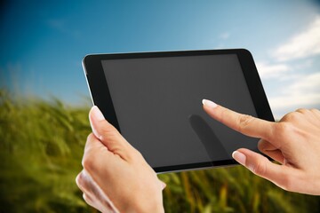 A farmer works with his tablet in a field. An agronomist walks the earth, assessing a plowed field in autumn. Agriculture. Smart farming technologies.