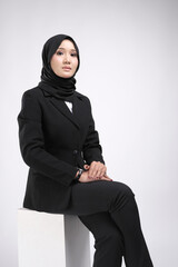 Fototapeta premium Portrait of a female wearing a hijab, a form of lifestyle garments for Muslim women, isolated on a background. Eid festive and hijab fashion concept