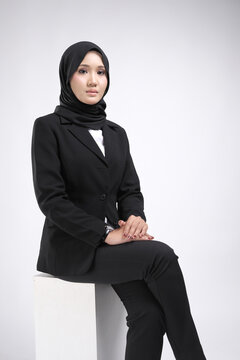 Portrait of a female  wearing a hijab, a form of lifestyle garments for Muslim women, isolated on a background. Eid festive and hijab fashion concept