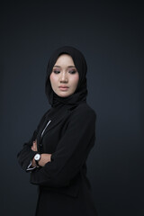 Portrait of a female  wearing a hijab, a form of lifestyle garments for Muslim women, isolated on a background. Eid festive and hijab fashion concept