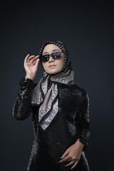 Portrait of a female  wearing a hijab, a form of lifestyle garments for Muslim women, isolated on a background. Eid festive and hijab fashion concept