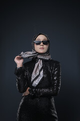 Portrait of a female  wearing a hijab, a form of lifestyle garments for Muslim women, isolated on a background. Eid festive and hijab fashion concept
